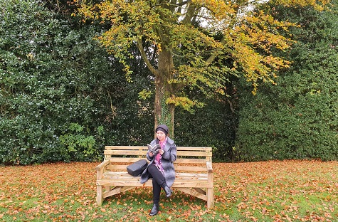 woman sitting on bench reading a book